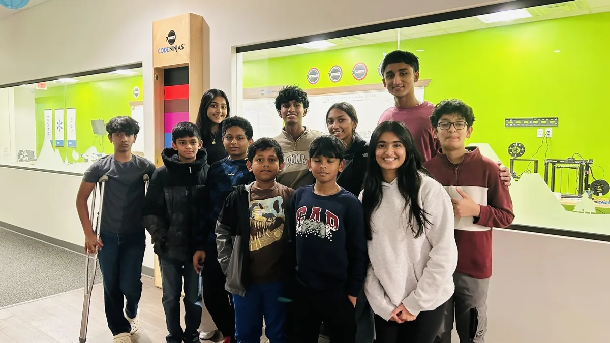 A group of middle school students together after a workshop.