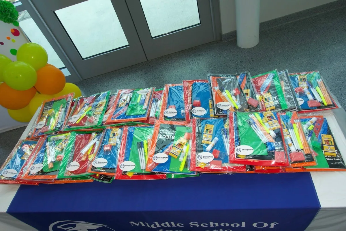 School supplies sorted on a SkillSphere table before being packed into kits.