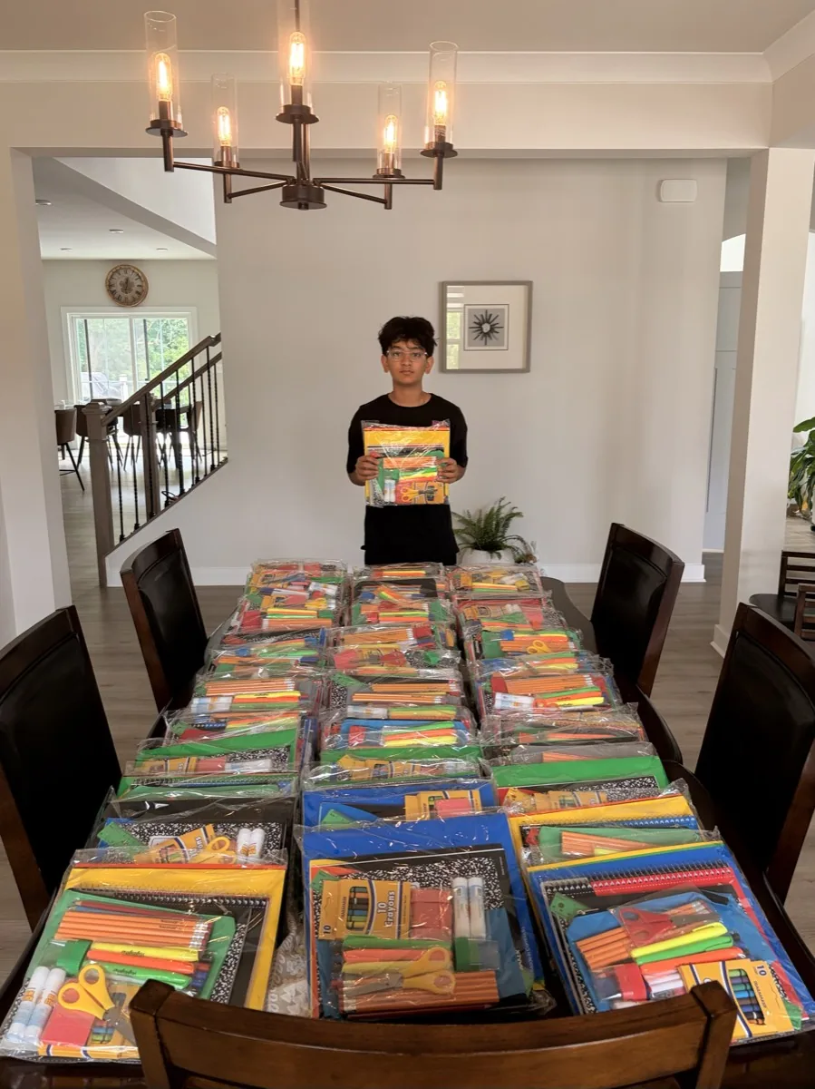 Supply kits lined up along a long dining table.
